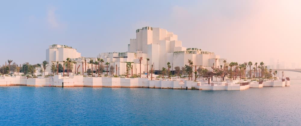 The white-terraced Natural History Museum Abu Dhabi seen across the water