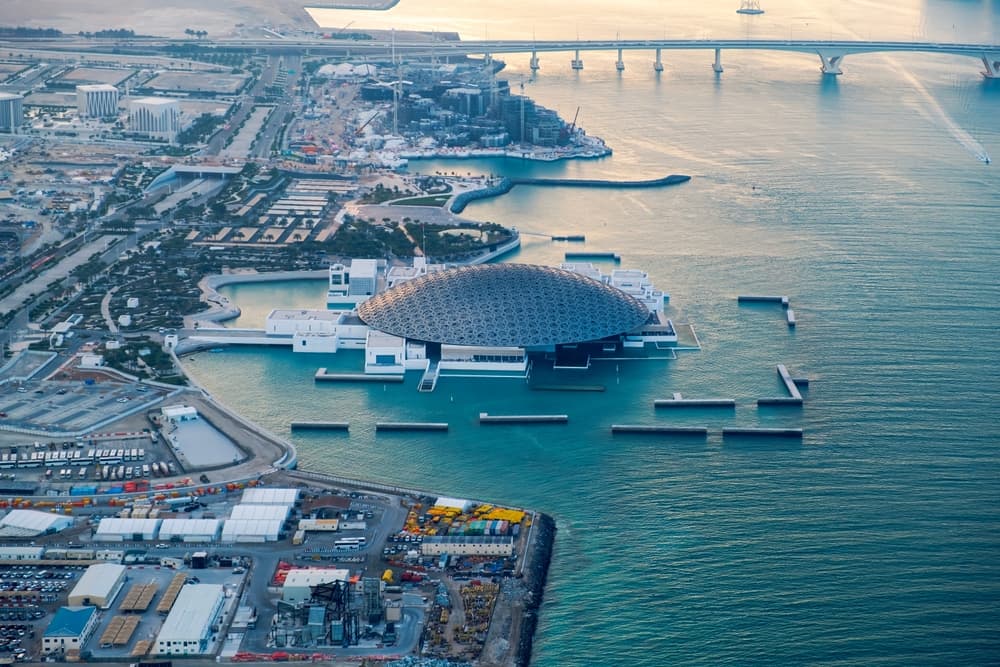 Aerial view of Saadiyat Island with the Louvre Abu Dhabi dome and the connecting bridge at dawn
